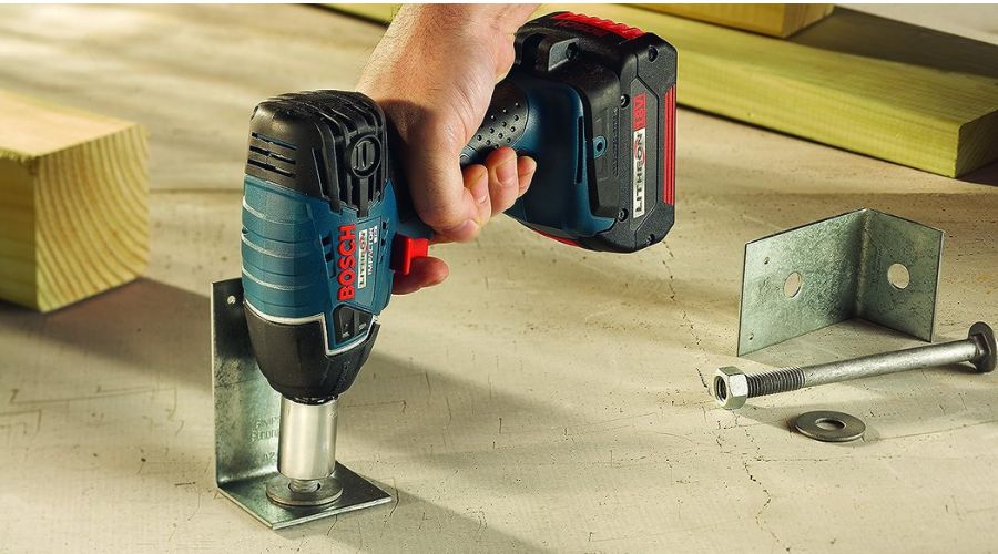 An image of a man using Bosch 24618-01 18-Volt Lithium-Ion 1/2-Inch Square Drive Impact Wrench Kit, one of the best 1/2 cordless impact wrench models 
