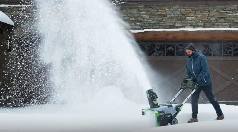 An image showing EGO Power+ SNT2112 21-Inch 56-Volt Lithium-Ion Cordless Snow Blower with Steel Auger, one of the best cordless snow blowers in use to clear snow in the winter