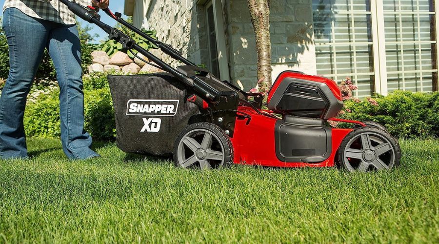 An image of Snapper XD 82V MAX Cordless Electric 21" Push Lawn Mower in use by a man, a powerful model among the best cordless lawnmower