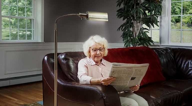 A woman using  daylight24 402051-07 Natural Daylight Battery Operated Cordless Floor Lamp, am example of cordless lamp