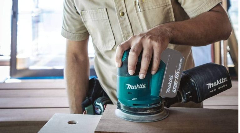 An image showing Makita XOB01Z 18V LXT Lithium-Ion Cordless 5-inch Random Orbit Sander, one of the best cordless sander in use to smoothen a wooden surface